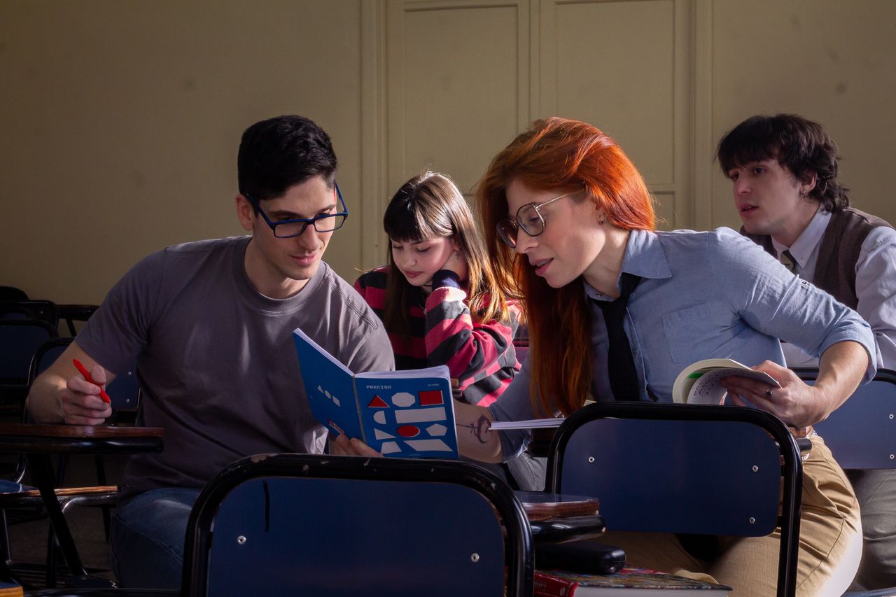 A group of students studying together in a classroom, illustrating collaborative learning.
